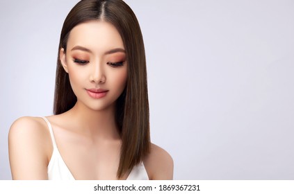 Beautiful Asian Woman With  Straight Hair. Beauty Chinese  Girl With Clean And White Skin.