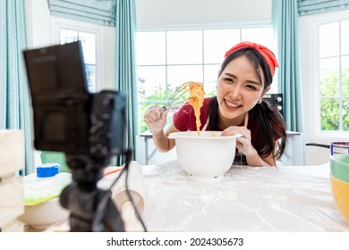 Beautiful Asian Woman Teaching How To Make Bread Bakery And Using The Camera To Record Live Online Social Media Vlogger Or Small Business Blogger Live Streaming Online, Live, Zoom.