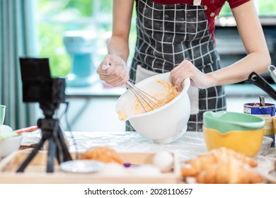 Beautiful Asian Woman Teaching How To Make Bread Bakery And Using The Camera To Record Live Online Social Media Vlogger Or Small Business Blogger Live Streaming Online, Live, Zoom.