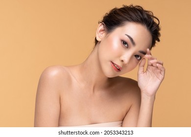Beautiful Asian woman touching eyebrow smile with clean and fresh skin Happiness and cheerful with positive emotional,isolated on Beige background,Beauty Cosmetics and spa Facial treatment Concept