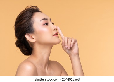 Beautiful Asian woman touching nose smile with clean and fresh skin Happiness and cheerful with positive emotional on Beige,Plastic Surgery nose,Beauty Cosmetics and spa facial treatment Concept