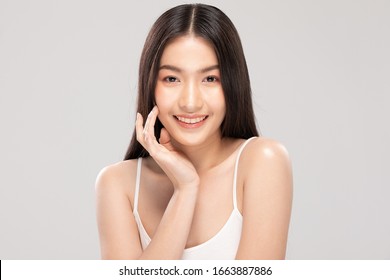 Beautiful Asian woman touching soft cheek smile with clean and fresh skin Happiness and cheerful with positive emotional,isolated on white background,Beauty and Cosmetics Concept