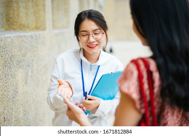 Beautiful Asian Woman Tour Guide Talking To Traveler And Giving Travel Infomation.