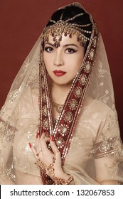 Beautiful asian woman in traditional clothing with bridal makeup and jewelry.