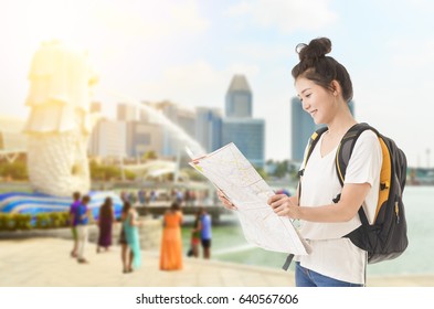 Beautiful Asian Woman Travel In Singapore Smiling And Looking At Map With Her Baggage