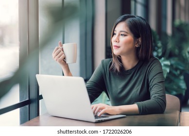 Beautiful Asian Woman Using Laptop Computer Online Working From Home ,  E-Learning , Online Shopping , E-Commerce , Freelance Concept - Healthcare And Social Distancing Concept