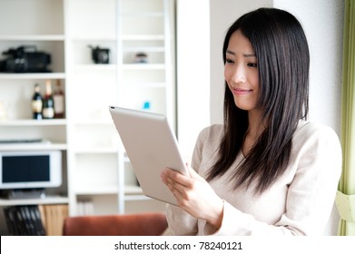 Beautiful Asian Woman Using Tablet Computer