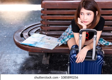 Beautiful Asian Woman Is Waiting Some Taxi Or Bus To Pick Her Up At Train Or Bus Station. It’s Arrival Late. Gorgeous Woman Feels Boring And Unhappy Because She Is Waiting For Long Time. Copy Space