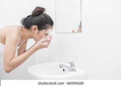 Beautiful Asian Woman Is Washing Her Face 