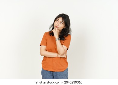 Beautiful Asian Woman Wearing Orange Color T-Shirt Thinking gesture Isolated On White Background