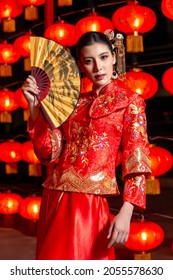 Beautiful Asian woman wearing a traditional red cheongsam on Chinese New Year.