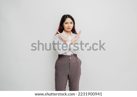 Beautiful Asian woman wearing white shirt with hand gesture pose rejection or prohibition with copy space