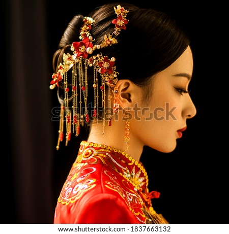 Beautiful Asian woman in wedding dress in dark background