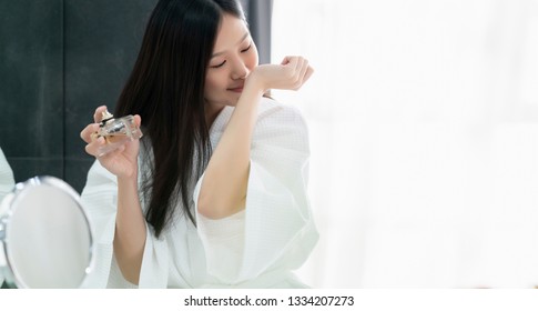 Beautiful Asian Woman In White Bathing Dress Enjoy Good Smell Of New Perfume Bathroom Background