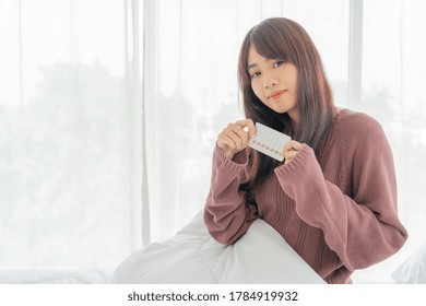 Beautiful Asian Women Holding Birth Control Pill