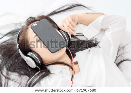 beautiful asian women Lie down and listen to music