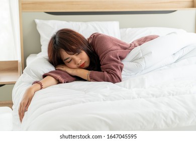 beautiful Asian women sleeping on bed in the morning - Shutterstock ID 1647045595