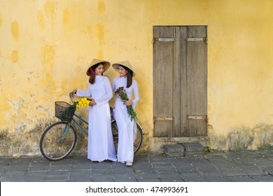 Beautiful asian women with Vietnam culture traditional dress, Ao dai is famous traditional costume, vintage style, Hoi an Vietnam town.