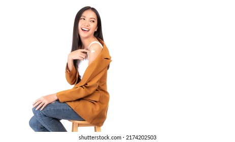 Beautiful Asian Young Woman Smile And Showing Her Arm After Getting The Covid-19 Vaccine Dose Antivirus Vaccination - Copy Space