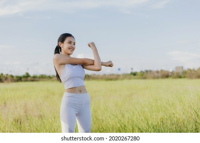 Beautiful Asian young woman stretching exercises outdoor. Healthy women concept. - Shutterstock ID 2020267280