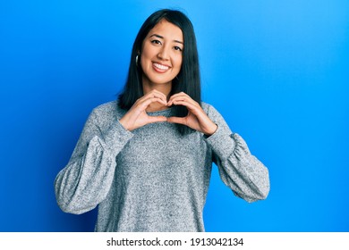 Beautiful Asian Young Woman Wearing Casual Clothes Smiling In Love Doing Heart Symbol Shape With Hands. Romantic Concept. 