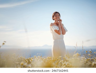 Beautiful Asian young woman in white dress outdoor in flower field under Rhodes city and above sea during sunset. embracing fresh air and engaging in outdoor activities. strong wind - element of - Powered by Shutterstock