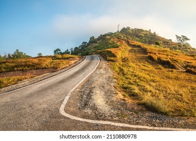 Beautiful Asphalt Country Road Side On The Green Mountain Background In Morning Sunlight, Phetchabun Thailand. Road Trip, Travel Holiday Or Transportation Concept.