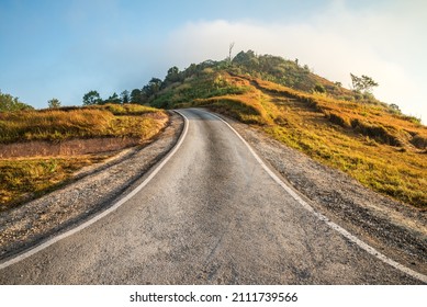 Beautiful Asphalt Country Road Side On The Green Mountain Background In Morning Sunlight, Phetchabun Thailand. Road Trip, Travel Holiday Or Transportation Concept.