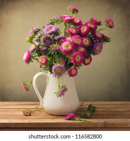 Beautiful aster flower bouquet on wooden table