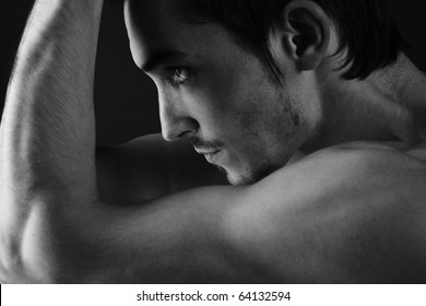 Beautiful athletic caucasian man on dark background
