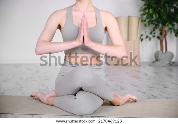 Beautiful athletic female\
body in a half-lotus position. Practicing yoga, meditation and\
tranquility.