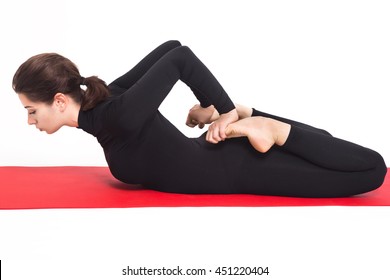 Beautiful athletic girl in black suit doing yoga. bhekasana asana - frog pose . Isolated on white background.