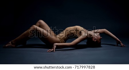 Similar – Young woman in black lingerie in chiaroscuro lighting