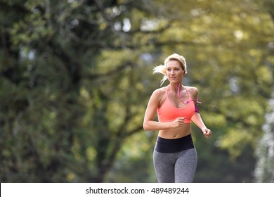 Beautiful Athletic Woman Running In Forest