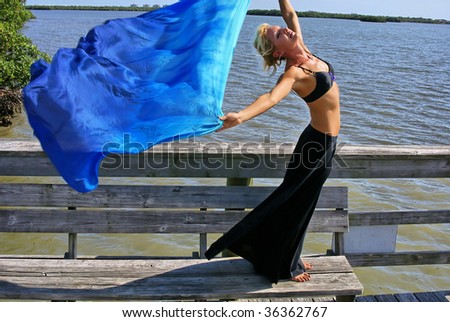 beautiful athletic woman stretching in the sun doing yoga