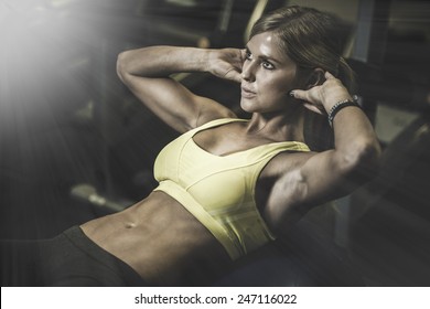beautiful athletic woman working ab intervals in fitness