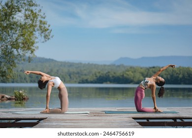 Beautiful attractive Asian woman practice fitness yoga pose on the pool above the Mountain peak in front of nature lake views, Feel so comfortable lifestyle and relax exercise in holiday morning - Powered by Shutterstock