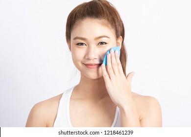 Beautiful Attractive Asian woman using Facial oil clean film to removal oily on face for face fresh skin feeling so fresh and clean,Beauty Concept,Isolated on grey background