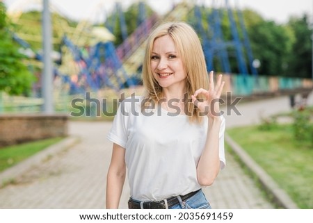 A beautiful and attractive Caucasian woman is showing Okay gesture. Approval gesturing.