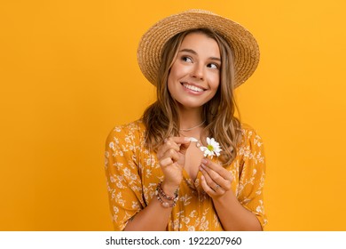 Beautiful Attractive Stylish Woman In Yellow Dress And Straw Hat Holding Daisy Flower Romantic Mood Posing On Yellow Background Isolated In Love Summer Fashion Trend Style, Natural Look