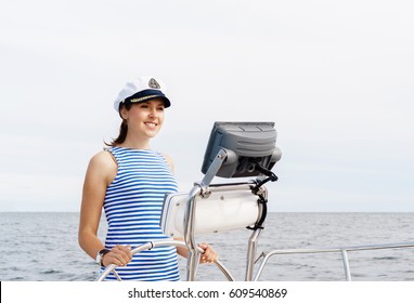Beautiful, attractive young girl pilots a boat Mediterranean Sea. Traveling, journey, tourism, concept.