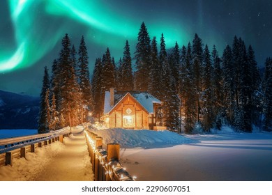 Beautiful Aurora borealis or Northern Lights over Emerald Lake Lodge glowing in the night at Yoho national park, Alberta, Canada - Powered by Shutterstock