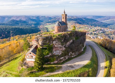 Beautiful autumn aerial view of St. Leon chapel dedicated to Pope Leo IX atop of Rocher de Dabo (Rock of Dabo), red sandstone rock butte, and Moselle-Vosges mountains and valleys. Lorraine, France.