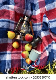 Beautiful Autumn Composition With Vintage Lantern, Mug, Coffee Turk, Blue Red Wool Blanket, Apples And Pears, Camping, Picknic Style