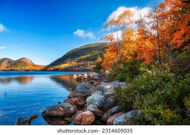 beautiful autumn landscape with mountains in colorful autumn trees on the lake. Acadia National Park. USA. Maine.