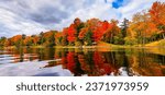 Beautiful autumn reflected on lake extremely colorful in Huntsville Ontario.   