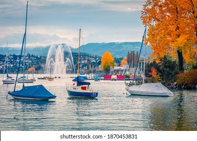 Beautiful autumn scenery. Attractive autumn cityscape of Zurich city, Switzerland, Europe. Picturesque morning scene of Zurich Lake (Zurichsee) with fountain anf yachts.