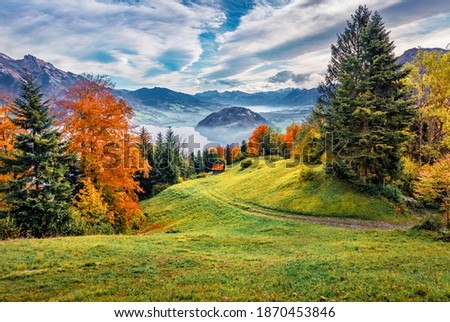 Beautiful autumn scenery. Attractive morning view of outskirts of  Stansstad town, Switzerland, Europe. Exciting autumn scene of  Lucerne lake, Swiss Alps. Landscape photography.
