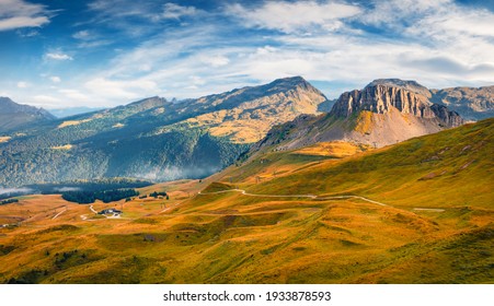 Beautiful autumn scenery. Breathtaking morning view of the top of Rolle pass. Nice autumn scene of Dolomite Alps. Colorful landscape of mountain valley, Trentino province, Italy, Europe. 