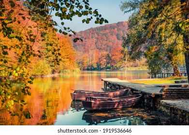 Beautiful autumn scenery. Stunning morning view of pure water lake with boats in Plitvice National Park. Colorful autumn scene of Croatia, Europe. Beauty of nature concept background.